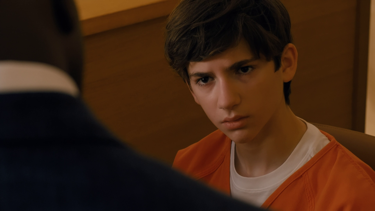 Daniel, in an orange jail jumpsuit, stares across the table at his lawyer during questioning in Cupertino.