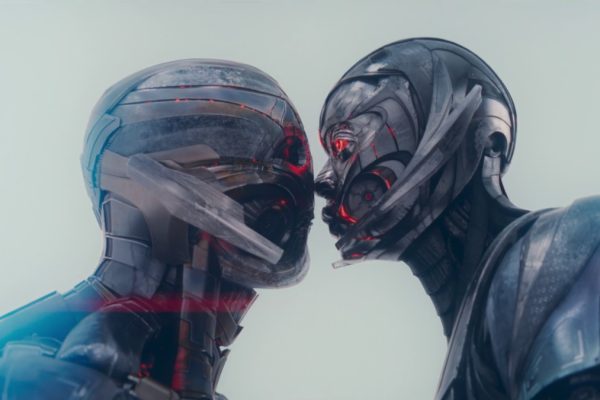 Ultron and Jocasta kiss, their metallic synthetic faces pressed together against a pale sky, in VisionQuest