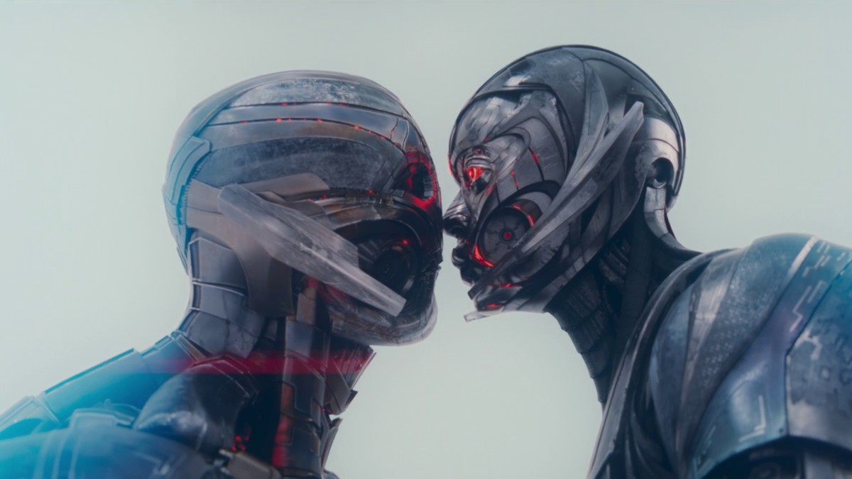 Ultron and Jocasta kiss, their metallic synthetic faces pressed together against a pale sky, in VisionQuest